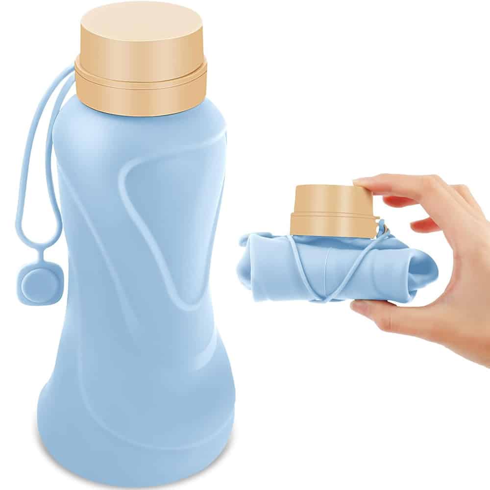 Green silicone table mat designed in the shape of a leaf, placed on a wooden dining table with a plate, fork, and glass, showcasing its food-grade, non-slip, and decorative qualities.