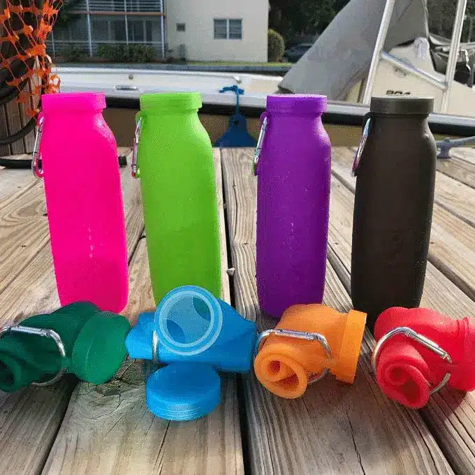 Collapsible silicone bottles manufactured in China for travel and sports use.