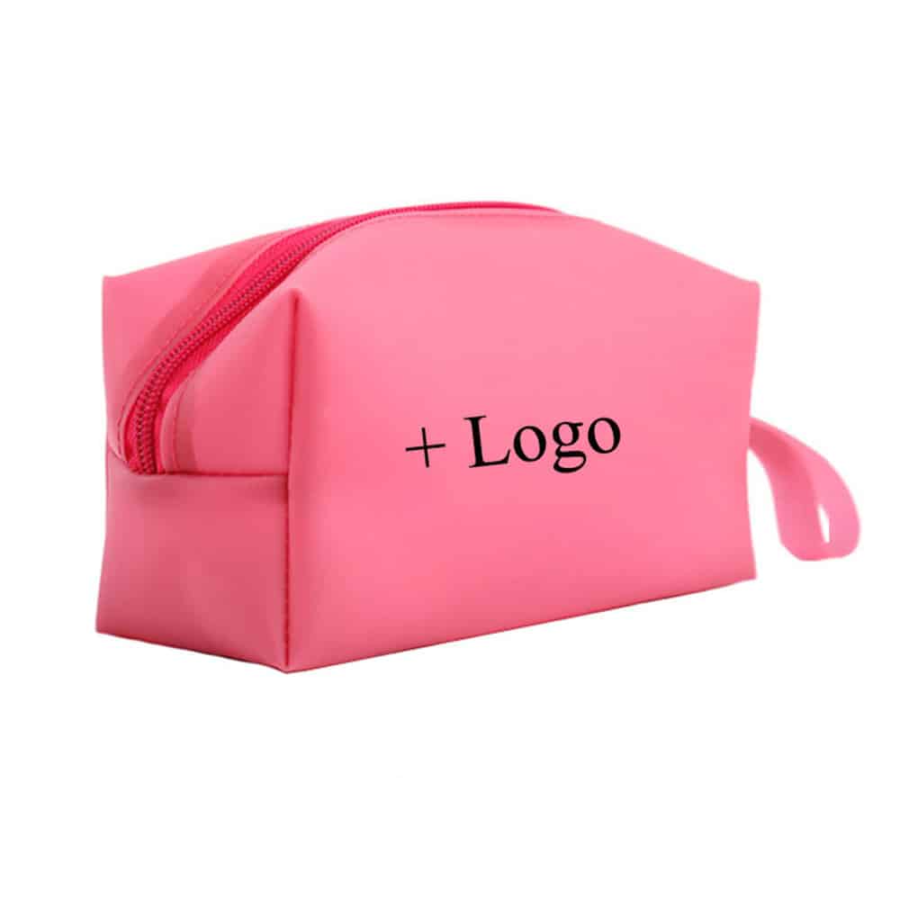 Green silicone table mat designed in the shape of a leaf, placed on a wooden dining table with a plate, fork, and glass, showcasing its food-grade, non-slip, and decorative qualities.