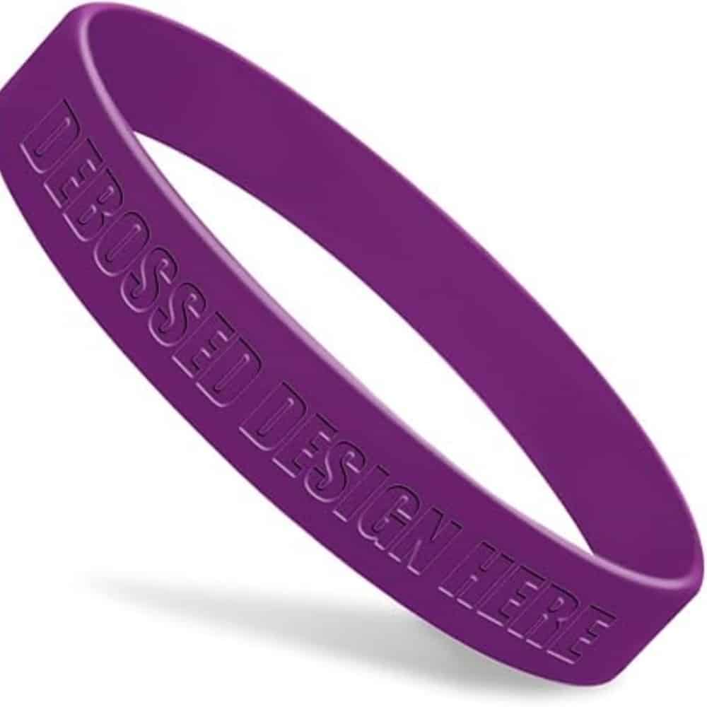 Green silicone table mat designed in the shape of a leaf, placed on a wooden dining table with a plate, fork, and glass, showcasing its food-grade, non-slip, and decorative qualities.